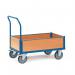 In this image, two slingsby platform trucks from Fetra are displayed. The trucks have a low box platform design and feature sturdy wheels and a handle for easy transportation. They appear to be in good condition and ready for use.