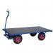 The image shows a row of sturdy slingsby warehouse trolleys. Each trolley has a Konga turntable platform and is equipped with brakes for added safety. The trolleys are lined up neatly, ready to transport heavy loads within the warehouse.