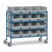 In the picture, there are several Fetra Storage Bins on top of euro container trolleys. The containers are stacked neatly and appear to be made of sturdy material. The trolleys have wheels for easy transportation. The overall image gives off a professional and organized appearance.