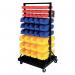 The photo shows an organized warehouse with workers from GPC Industries Ltd picking and packing double sided mobile bin trolley kits. A total of 90 bins can be seen, labeled with numbers and placed neatly on the trolley. The trolley allows for easy movement and efficient organization of items.