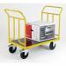 The photograph features sturdy Kongamek platform trucks with double-ended construction and solid rubber tires. The trucks have a large capacity and a platform size of 500 x 750mm.