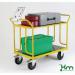 The image shows several Kongamek heavy duty warehouse trolleys made of laminated wood shelves. The trolleys are sturdy and spacious, designed to handle heavy loads. They are equipped with durable wheels for easy movement.