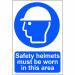 The photograph shows a bright yellow sign with bold black lettering that reads Safety helmets must be worn in this area. The sign is made of 1.2mm recyclable PP and measures 200 x 300mm. The background features a spectrum of colors, creating a vibrant and eye-catching display.