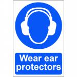 The photo captures a bright yellow sign with bold black text reading Wear ear protectors - 1.2mm Recyclable PP against a white background. The sign is 200 x 300mm in size and features the Spectrum Industrial branding. A person wearing ear protectors is also shown on the sign, emphasizing the message.