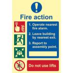 This picture features a Spectrum Industrial Fire Safety Sign with a Fire Action Procedure, made of 1.3mm rigid self-adhesive photoluminescent material. The sign measures 200mm x 300mm and is clearly labeled with the appropriate imagery and text.