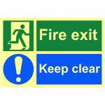 The picture shows a bright red and white fire exit sign with bold text, mounted on a 1.3mm rigid self adhesive material. The sign glows in the dark thanks to its photoluminescent coating, and measures 300mm x 200mm. The sign features the words Fire Exit Keep Clear in large, clear lettering, indicating the importance of keeping this area free from obstructions. Perfect for any industrial setting to ensure safety and compliance.