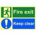 The picture shows a bright red and white fire exit sign with bold text, mounted on a 1.3mm rigid self adhesive material. The sign glows in the dark thanks to its photoluminescent coating, and measures 300mm x 200mm. The sign features the words Fire Exit Keep Clear in large, clear lettering, indicating the importance of keeping this area free from obstructions. Perfect for any industrial setting to ensure safety and compliance.