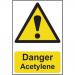 The photograph captures a Spectrum Industrial Danger Sign displaying the words Danger Acetylene in bold black text on a vibrant yellow background. The sign is made of 1.2mm thick recyclable PP material and measures 200 x 300mm. It serves as a clear warning of potential danger in an industrial environment.