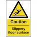 A photo of Spectrum Industrial caution signs would show bright yellow signs with bold black lettering. The sign reads Caution Slippery floor surface and is made of 1.2mm recyclable PP material. It measures 200 x 300mm in size and has the product code 11040. The background of the photo is likely a commercial or industrial setting.