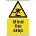 This photo captures a self-adhesive vinyl sign from Spectrum Industrial with bold lettering that reads Mind The Step. It features a vibrant yellow background with the dimensions of 200mm x 300mm. The warning sign is designed to alert individuals to uneven surfaces and potential hazards.