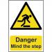 In the photo, there is a Spectrum Industrial danger sign that reads Danger Mind the step in bold red letters. The sign is made of 1.2mm recyclable PP material and measures 200 x 300mm. It features a simple but effective design with black and yellow colors, making it easily noticeable. The sign is placed on a flat surface, possibly a floor, with a warning symbol and text indicating potential danger or hazard. Overall, it is a clear and visible sign that effectively alerts individuals to beware of potential danger and take caution.