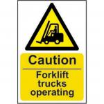 The picture shows a rectangular industrial sign with a yellow background and bold black font stating Caution Fork Lift Trucks Operating. The sign is made of self-adhesive vinyl and measures 200mm by 300mm. In the top left corner is the logo for Spectrum Industrial.