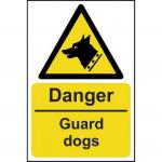 The photo showcases a bright yellow danger sign from Spectrum Industrial with the words Danger Guard Dogs in bold black font. The sign is made from 1.2mm thick recyclable PP material and measures 400 x 600mm. In the background, there are images of aggressive dogs. The sign is designed to warn people of potential danger and to exercise caution in the area.