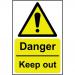 This photograph displays a collection of Spectrum Industrial danger signs. Made from 1.2mm recyclable PP, the signs measure 400 x 600mm and feature the phrase Danger Keep Out to warn viewers. The signs are brightly colored and have clear, bold lettering for easy readability.