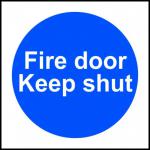 The photo shows Spectrum Industrial Fire Safety Signs that read Fire door Keep shut on a black background. The signs are made of 1.2mm thick recyclable PP and are 100 x 100mm in size. The bold white text is easy to read and ensures clear communication of the safety message.