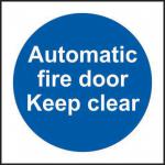 The photo shows a Spectrum Industrial Fire Safety Sign for an automatic fire door. Made from 1.2mm recyclable PP material, the sign reads Keep Clear in bold letters. It is 100 x 100mm in size and has the product number 11337 printed on the side.