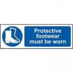 The photograph shows a Spectrum Industrial PPE sign for protective footwear, measuring 600mm x 200mm. The sign is made of self-adhesive vinyl and features bold text and a universal symbol, clearly stating that wearing protective footwear is required in the area.