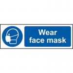 In the image, there are several Spectrum Industrial PPE signs displayed. The signs are made of 1.2mm recyclable PP and measure 600 x 200mm. Each sign has a clear message urging people to wear face masks for safety. The signs are bold and eye-catching with bright colors and large font.