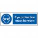 In the photograph, there is a vividly colored Spectrum Industrial PPE Eye Protection Must Be Worn Sign. It is made of Self-Adhesive Vinyl and measures 600mm x 200mm. The sign clearly states the necessary safety precaution and is suitable for industrial environments.