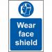 The picture shows a sign from Spectrum Industrial featuring a red and white design. The sign reads Wear Face Shield in bold black letters and has an image of a face shield in the center. It is made of self-adhesive vinyl and measures 400mm x 600mm. This sign is a vital reminder for industrial workers to wear protective gear for safety purposes.