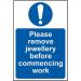 The image shows a bright yellow PPE sign from Spectrum Industrial with bold black lettering that reads Please Remove Jewellery Before Commencing Work. The sign is made of self-adhesive vinyl and measures 200mm x 300mm. It is designed to remind employees to remove all jewellery before starting work for safety reasons.
