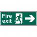 The photo shows a Spectrum Industrial Fire Safety Sign with the words Fire Exit and an arrow pointing to the right. It is made of self-adhesive vinyl and measures 600mm x 200mm. The sign is designed for fire safety in industrial settings.
