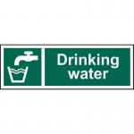 The photograph shows Spectrum Industrial Food Prep Signs Drinking water 1.2mm Recyclable PP (300 x 100mm) 12039, featuring bold, white lettering on a bright blue background. The sign is made of durable, recyclable material and is perfect for use in industrial food preparation areas. The size is 300 x 100mm, making it easy to read from a distance.
