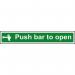 The photo shows a red and white self-adhesive vinyl sign with the words Push Bar To Open in bold letters. The sign is designed for industrial fire safety and measures 600mm x 100mm. A clear image of the push bar symbol is also visible on the sign.