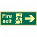 The photograph captures a Spectrum Industrial Fire Safety Signs Fire Exit Sign in bright red and white, indicating the direction with a man arrow pointing right. The sign is made of a sturdy 1.3mm rigid material and features a self-adhesive back for easy installation. The photoluminescent properties make it visible even in low-light settings. The size of the sign is 400mm by 150mm.