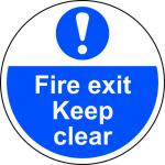 This floor graphic features the Spectrum Industrial Fire & Safety logo and text, with a bold arrow pointing towards a clear fire exit. The anti-slip laminated finish ensures safety while the 400mm diameter makes it highly visible. Perfect for industrial settings.