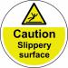 The Spectrum Industrial Floor Graphics Caution Slippery Surface Floor Graphic is a circular, laminated sign measuring 400mm in diameter. It features a warning symbol and text indicating a slippery surface, providing essential safety information for anyone passing by.