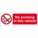 The picture shows a small rectangular sign with bold white lettering on a black background. The words No Smoking In This Vehicle are prominently displayed in the center. The sign is made of self-adhesive vinyl and measures 150mm x 50mm. It is designed to be used in industrial settings to indicate a non-smoking area.