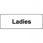 This photograph shows a Spectrum Industrial washroom sign specifically designed for ladies. The sign is made of self-adhesive vinyl and measures 300mm x 100mm. The simple yet bold design makes it easily recognizable and perfect for any industrial setting.