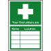 In the photo, a Spectrum Industrial First Aid Sign is visible, made of 1.2mm recyclable PP and measuring 200 x 300mm. The words Your first aider is... are prominently displayed on the sign, indicating its purpose. Bold and clear text makes it easily readable and highly visible.