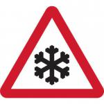 The photograph captures a section of Spectrum Industrial Road, featuring a temporary road sign with a triangular frame warning of the risk of ice. The bright yellow sign stands out against the grey background, standing tall at 750mm and providing critical information for drivers. Traffic signs and buildings can also be seen in the background, adding to the urban environment of the scene.