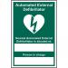 The photo shows a bright yellow industrial first aid sign, with a bold red cross and text reading Automated External Defibrillator Nearest. The self-adhesive vinyl sign measures 200mm by 300mm, making it easily visible and recognizable in any industrial setting.