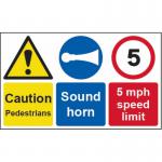 This photograph features a bright yellow Spectrum Industrial Caution Sign with bold black text and symbols. The sign cautions pedestrians to be careful and includes a reminder to sound your horn. The speed limit is set at 5mph and the sign is made of 1.2mm recyclable PP. Its size is 500 x 300mm.