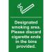 This photograph features a Spectrum Industrial No Smoking Sign with a designated smoking area design. Made of 1.2mm recyclable PP, the sign measures 200 x 300mm and reminds people to properly discard cigarette ends.