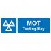 This photograph captures a bustling industrial road lined with bold, distinguishable traffic signs. In the background, a MOT testing bay can be seen, made from 1.2mm recyclable PP material. The photograph is 600 x 200mm in size and offers a clear, informative view of the busy business scene.