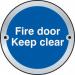 The photo shows a Spectrum industrial room sign featuring a fire door keep clear door disc. The disc is made of satin anodised aluminium and has a diameter of 75mm. This sign is perfect for clear and visible labeling in industrial settings.