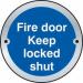 The picture shows a circular Satin Stainless Steel fire door sign for an industrial room. The sign reads Fire Door Keep Locked Shut and features a diameter of 75mm.