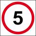 The picture shows a Spectrum Industrial road with a 5mph speed limit sign on a 3mm Foamex board measuring 400mm x 400mm. Traffic signs line the road, giving direction and warning to drivers. The bright and bold colors of the signs stand out against the grey background.