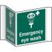 This sign features a bold red and white design with the words Emergency Eye Wash in capital letters. The background is a solid color with a prominent eye symbol in the center. Made of recyclable PP material, this sign is durable and measures 200mm across. The projection sign is easy to spot and ideal for industrial first aid settings.