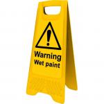 This photograph captures a pair of bright yellow industrial cleaning signs, warning of wet paint and featuring heavy duty A frame construction. The signs measure 620mm x 200mm and are perfect for outdoor use in commercial settings.