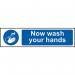 The photograph shows a collection of industrial Covid-19 and social distancing signs from Spectrum. One sign reads Now wash your hands and is made of 1.2mm recyclable PP material, measuring 200 x 50mm. The signs are designed to help promote safety and hygiene in the workplace.