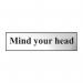 This photograph features a chrome effect Spectrum Industrial Room Sign that reads Mind Your Head in bold font. The sign is made of self-adhesive PVC material and measures 200mm x 50mm. The sleek and modern design is suitable for any industrial setting.