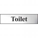 The photo shows a chrome-effect Spectrum Industrial Washroom Sign displaying the word Toilet. The self-adhesive PVC sign measures 200mm x 50mm and features sleek, modern design. Perfect for any industrial or commercial washroom setting.