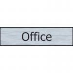 The picture shows a sleek Spectrum Industrial Room Sign for an office, made of stainless steel effect and measuring 200mm x 50mm. It has a self-adhesive backing and is made of PVC material. The sign appears to be professional and modern, with clean lines and a high-quality finish.