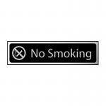 This photograph depicts a Spectrum Industrial No Smoking sign. The sign is black with a polished chrome effect and measures 200mm x 50mm. It is made of self-adhesive PVC material.