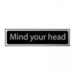The Spectrum Industrial Room Signs Mind Your Head Sign is sleek and modern, with a black and polished chrome effect. Made of self-adhesive PVC, it measures 200mm x 50mm. The sign clearly warns against low ceilings, keeping safety top-of-mind in industrial settings.